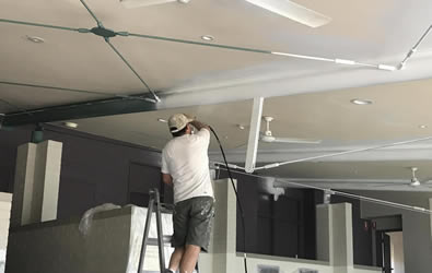 Rob painting ceiling with his partner